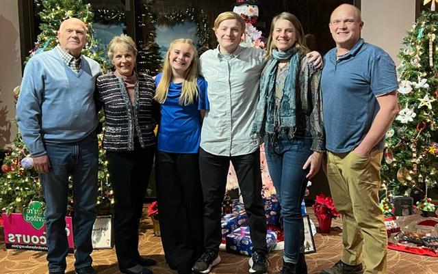 Patricia Long stands with her son, daughter-in-law and two grandchildren to her left and her husband, James, to her right.